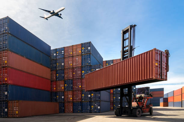 Forklift lifting a cargo container near an airport